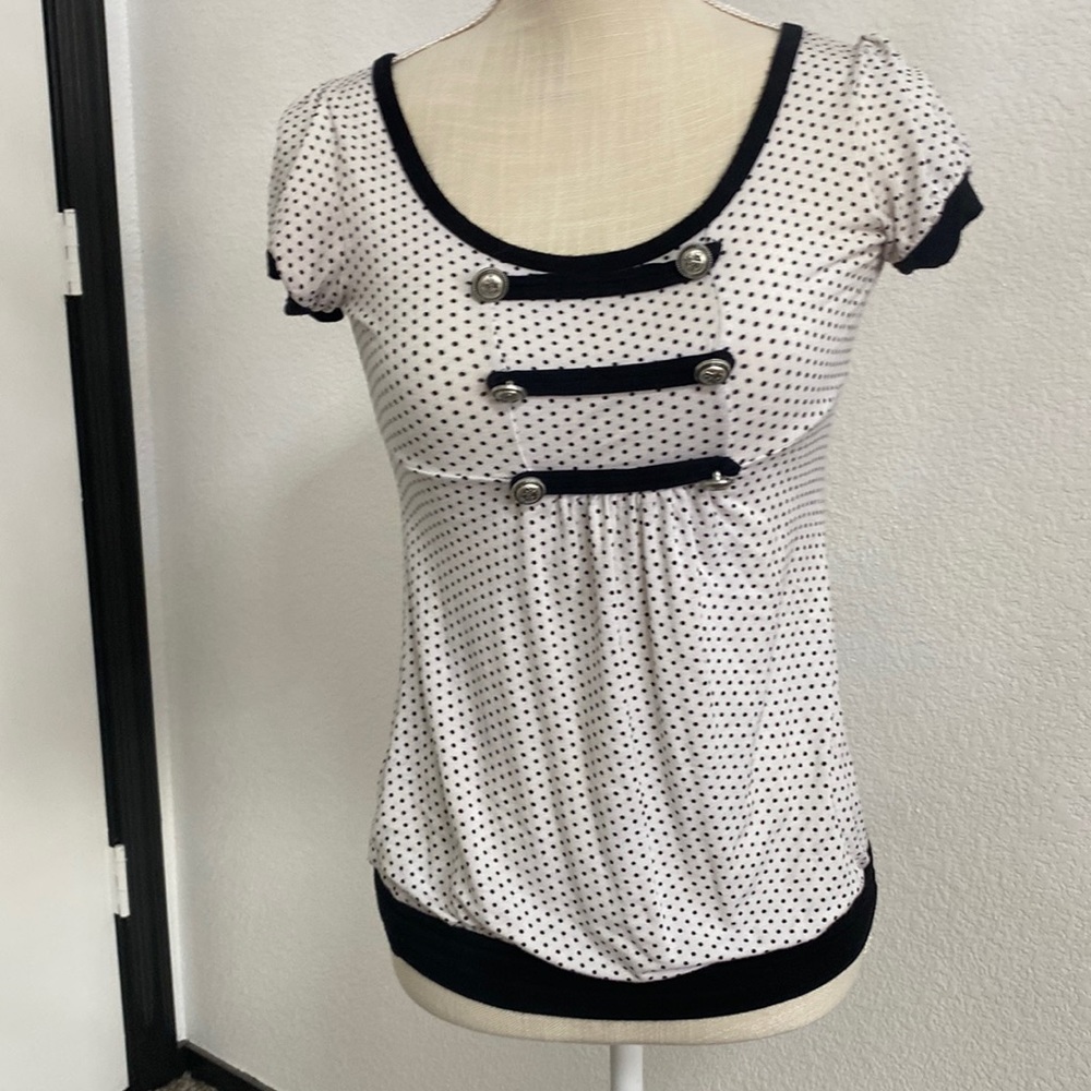 Black/White polka dot shirt with some finishing details around the breas…